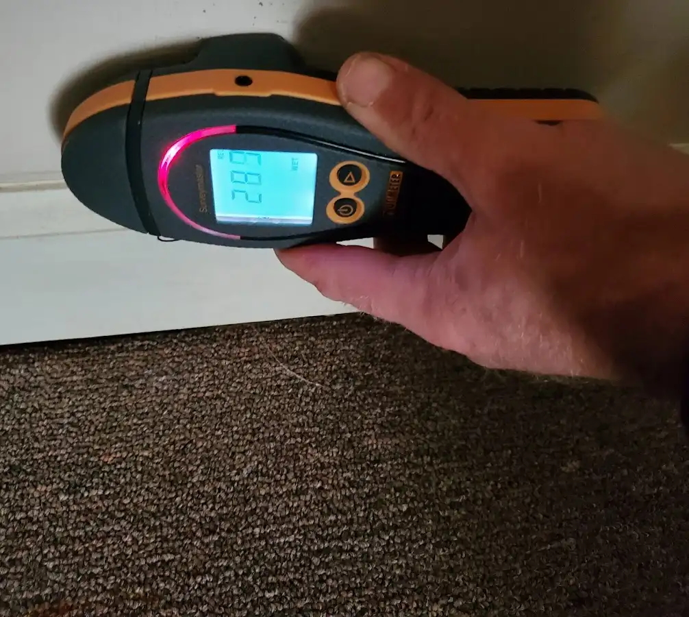 Moisture detection at baseboard during Storm Damage Restoration in Grayson